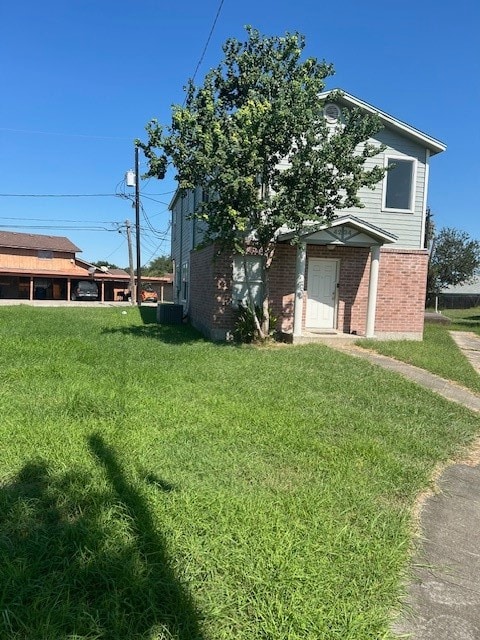 view of front of home with a front lawn and cooling unit