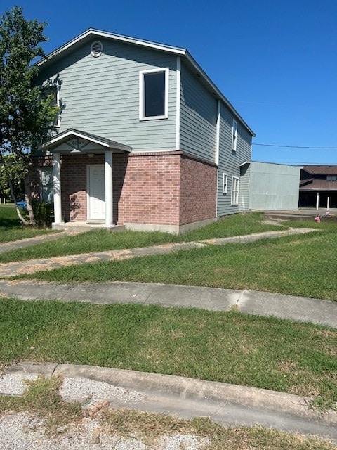 view of side of property with a yard