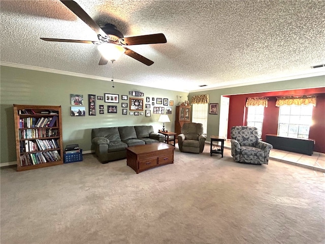 living room featuring carpet, a textured ceiling, ceiling fan, and ornamental molding