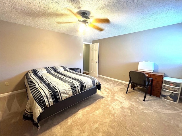 carpeted bedroom with ceiling fan and a textured ceiling