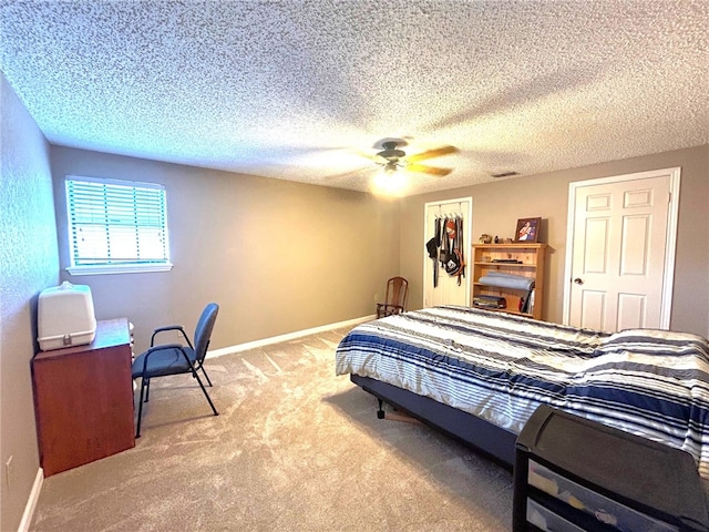 carpeted bedroom featuring ceiling fan, a closet, and a textured ceiling