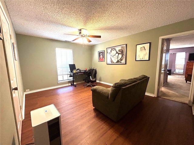 living room with ceiling fan, hardwood / wood-style floors, and a textured ceiling