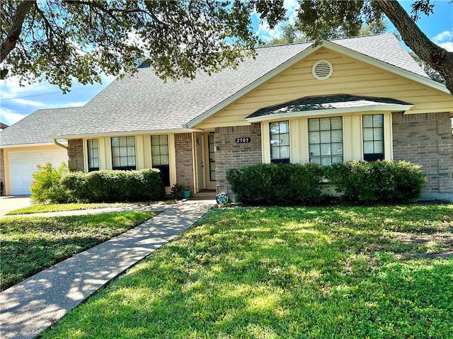 view of front of home featuring a garage and a front lawn