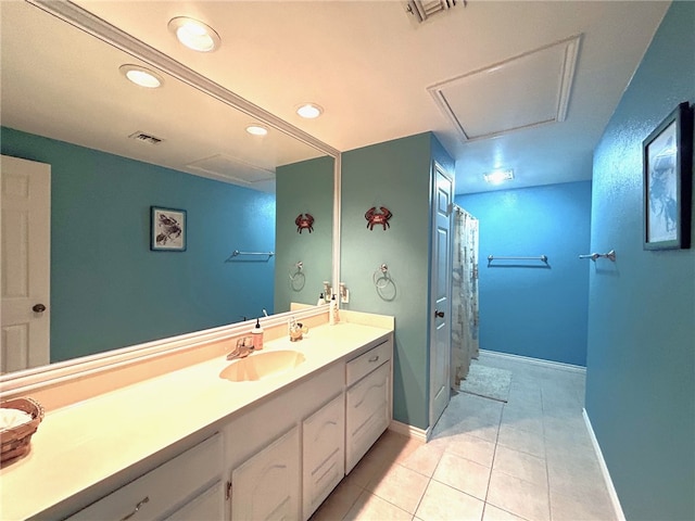 bathroom with tile patterned flooring, vanity, and walk in shower