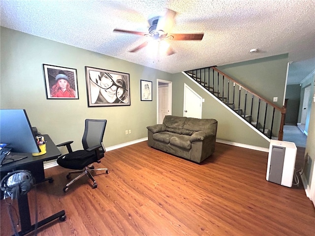 office area with a textured ceiling, hardwood / wood-style flooring, and ceiling fan