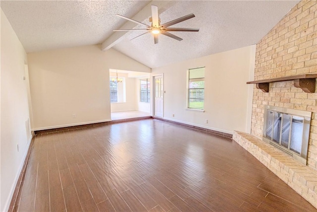 2721 Tumbleweed Dr, Corpus Christi, TX 78410 - unfurnished living room with dark wood-type flooring, a ceiling fan, a brick fireplace, a textured ceiling, and a chandelier