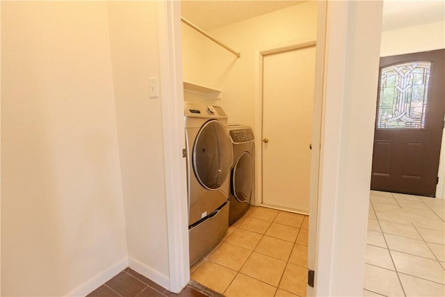 2721 Tumbleweed Dr, Corpus Christi, TX 78410 - laundry area with independent washer and dryer and light tile patterned flooring