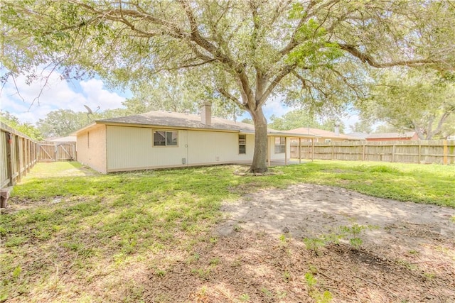 2721 Tumbleweed Dr, Corpus Christi, TX 78410 - rear view of house with a fenced backyard and a chimney