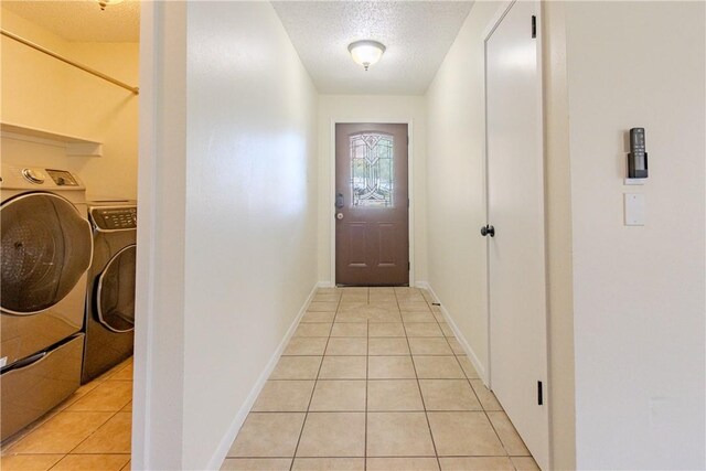 2721 Tumbleweed Dr, Corpus Christi, TX 78410 - doorway to outside featuring separate washer and dryer, light tile patterned floors, and a textured ceiling