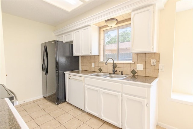2721 Tumbleweed Dr, Corpus Christi, TX 78410 - kitchen with dishwasher, black fridge, white cabinets, backsplash, and light tile patterned floors