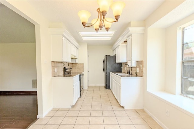 2721 Tumbleweed Dr, Corpus Christi, TX 78410 - kitchen with stainless steel range with electric stovetop, backsplash, a chandelier, white cabinets, and under cabinet range hood