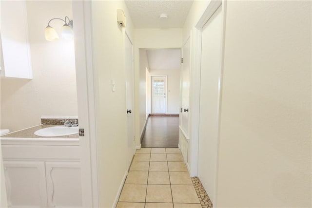 2721 Tumbleweed Dr, Corpus Christi, TX 78410 - hallway with light tile patterned floors and a textured ceiling