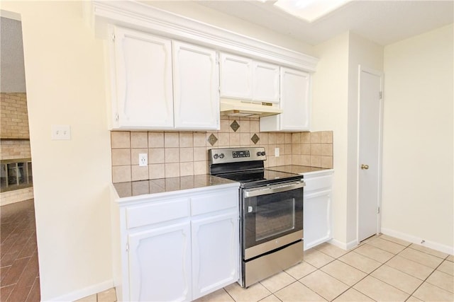 2721 Tumbleweed Dr, Corpus Christi, TX 78410 - kitchen featuring electric stove, under cabinet range hood, white cabinets, and tasteful backsplash