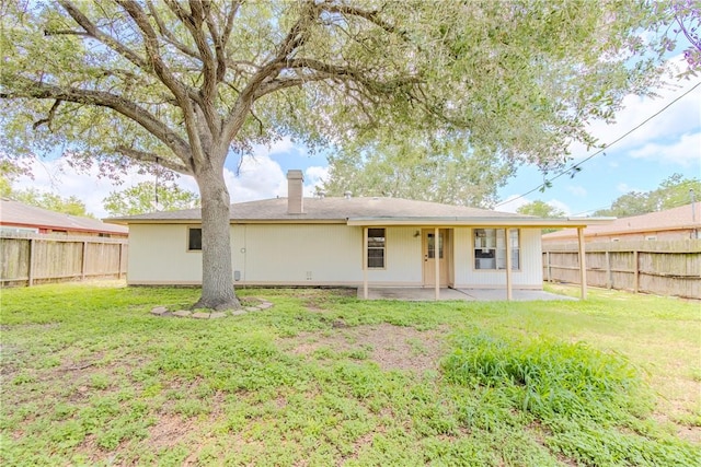 2721 Tumbleweed Dr, Corpus Christi, TX 78410 - back of property featuring a fenced backyard, a patio area, and a chimney