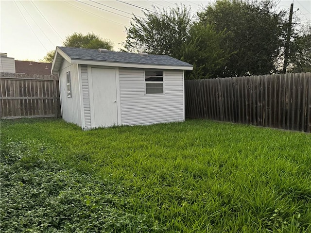 view of outbuilding with a yard