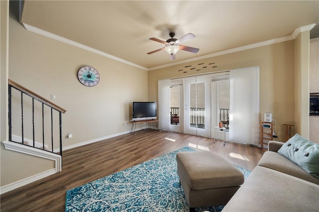 living room with crown molding, dark hardwood / wood-style flooring, and ceiling fan