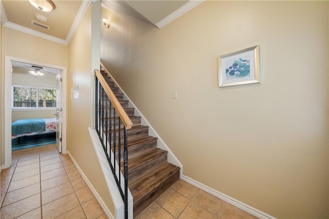 stairs featuring tile patterned floors and crown molding