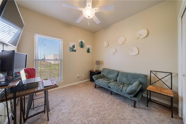 carpeted office space featuring ceiling fan