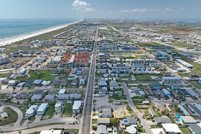 bird's eye view with a water view and a beach view