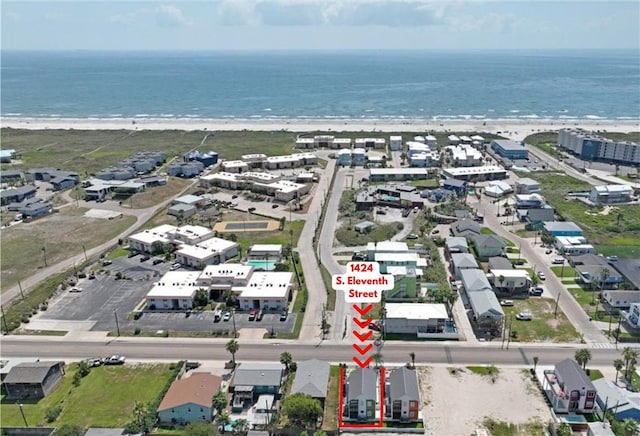 birds eye view of property featuring a water view and a view of the beach