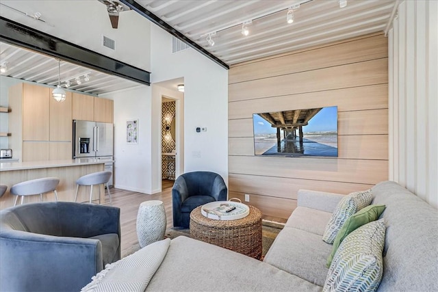 living room with rail lighting and light wood-type flooring