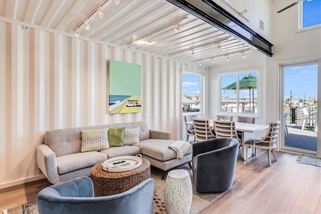 sunroom / solarium featuring track lighting