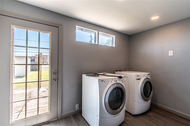 laundry area with dark hardwood / wood-style flooring and washing machine and clothes dryer