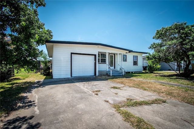 ranch-style home with a garage and a front yard