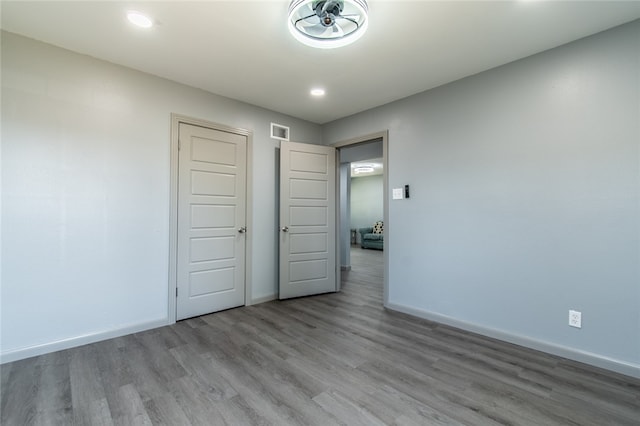 unfurnished bedroom with light hardwood / wood-style floors and a closet