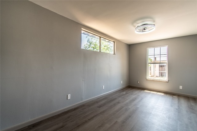 unfurnished room with dark hardwood / wood-style flooring