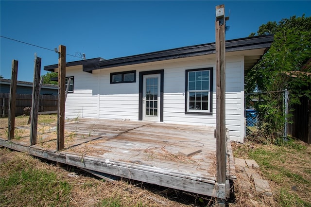 rear view of house featuring a deck