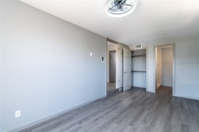 unfurnished bedroom featuring hardwood / wood-style flooring and a closet