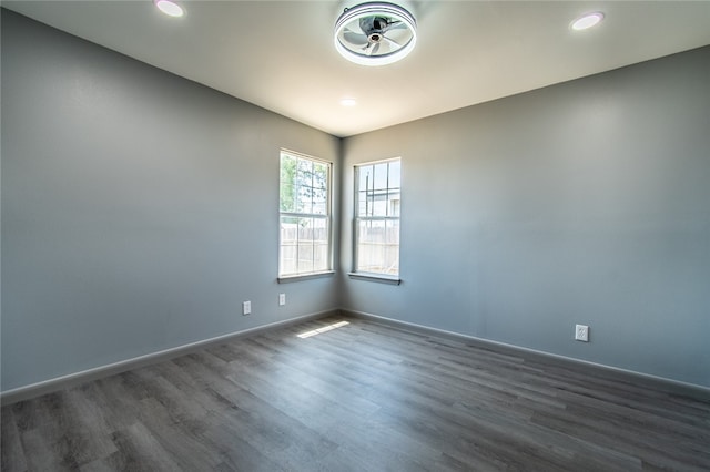 spare room with dark hardwood / wood-style flooring