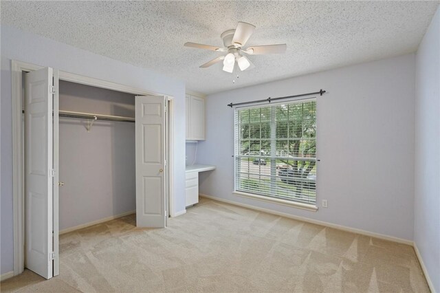 7617 Del Rio Dr, Corpus Christi, TX 78413 - unfurnished bedroom featuring light carpet, a closet, a textured ceiling, and a ceiling fan