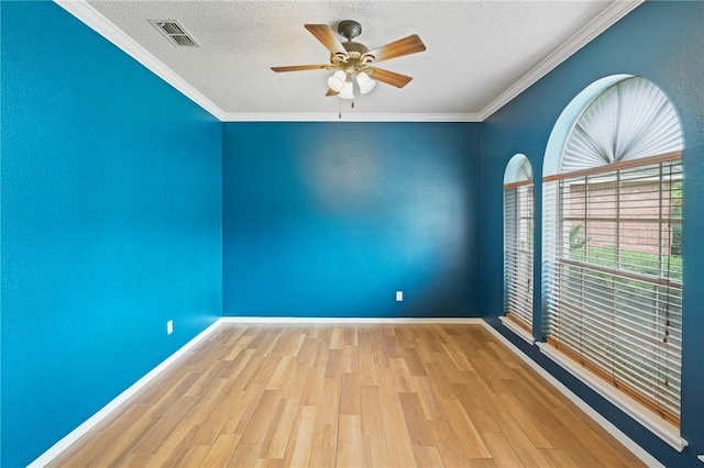 7617 Del Rio Dr, Corpus Christi, TX 78413 - spare room featuring a ceiling fan, a textured ceiling, wood finished floors, and crown molding
