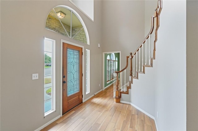 7617 Del Rio Dr, Corpus Christi, TX 78413 - foyer entrance featuring plenty of natural light, light wood-type flooring, a towering ceiling, and stairs