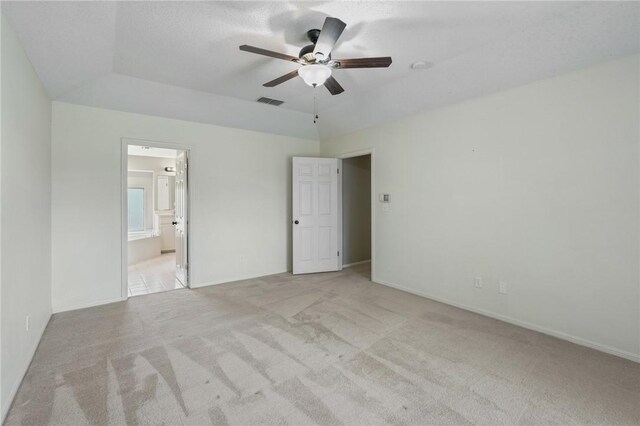 7617 Del Rio Dr, Corpus Christi, TX 78413 - unfurnished bedroom featuring light colored carpet, ensuite bathroom, and a ceiling fan