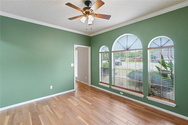 7617 Del Rio Dr, Corpus Christi, TX 78413 - empty room with healthy amount of natural light, a ceiling fan, a textured ceiling, crown molding, and wood finished floors
