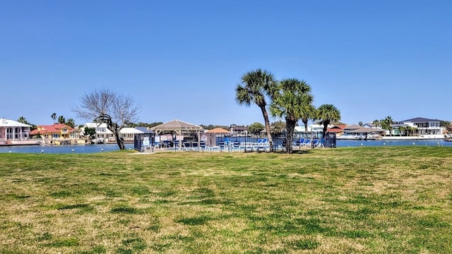 exterior space with a water view, a residential view, and a gazebo