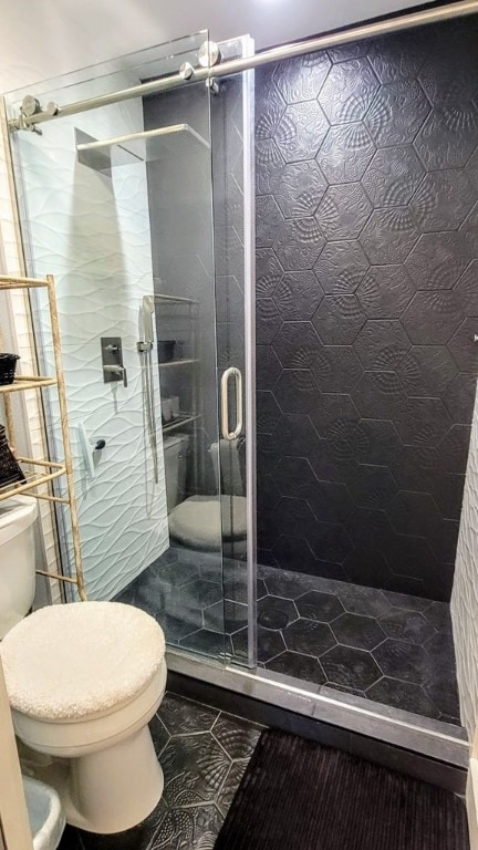 full bathroom with a shower stall and toilet