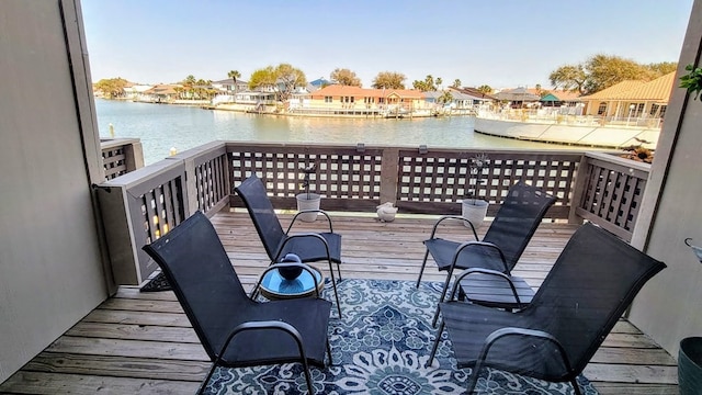 wooden deck featuring a water view and a residential view