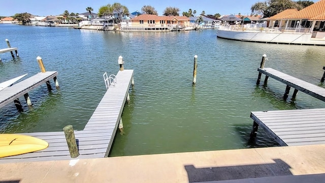 dock area featuring a water view and a residential view