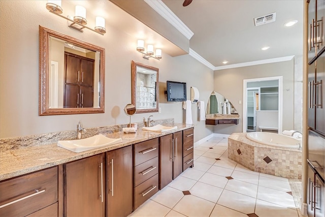 bathroom featuring tiled bath, vanity, tile patterned floors, and crown molding