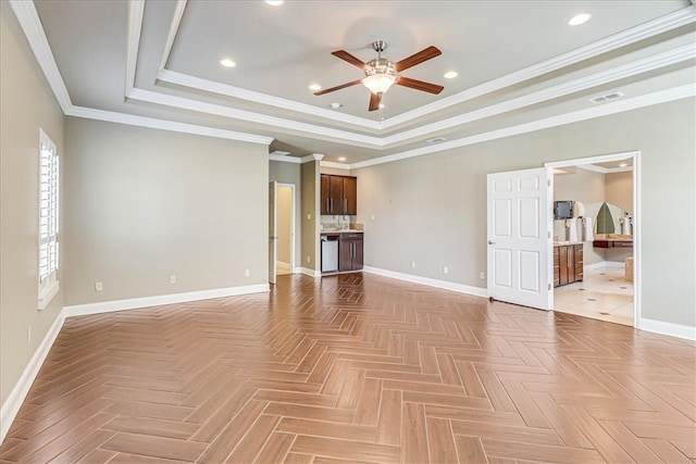 unfurnished living room featuring ceiling fan, parquet flooring, ornamental molding, and a raised ceiling