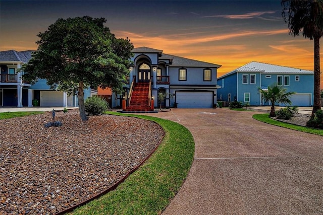 113 Bay Ct, Aransas Pass, TX 78336 - view of front facade featuring stairway, concrete driveway, an attached garage, and stucco siding