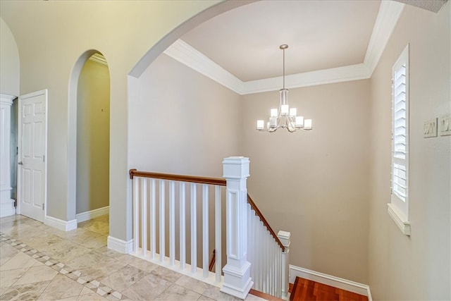 stairs with an inviting chandelier and crown molding