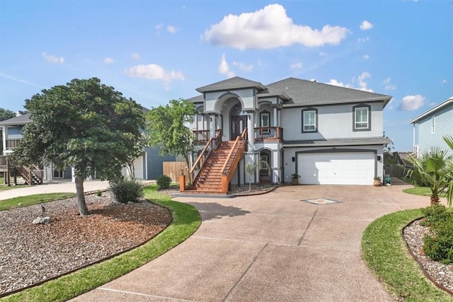 113 Bay Ct, Aransas Pass, TX 78336 - view of front facade featuring stairs, stucco siding, concrete driveway, a garage, and a porch