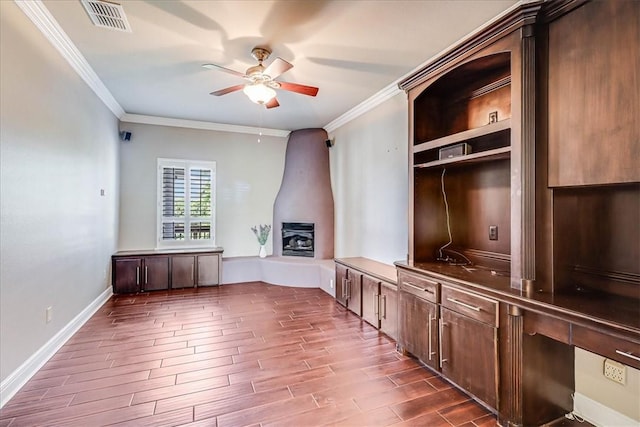 113 Bay Ct, Aransas Pass, TX 78336 - unfurnished office featuring ceiling fan, ornamental molding, dark wood-type flooring, baseboards, and a large fireplace
