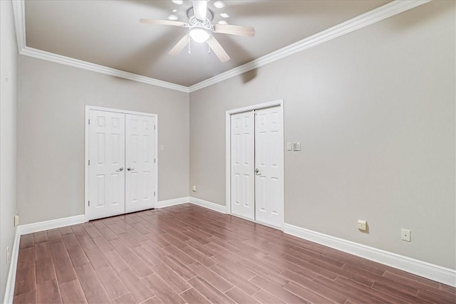113 Bay Ct, Aransas Pass, TX 78336 - unfurnished bedroom with ornamental molding, baseboards, wood finished floors, and a ceiling fan