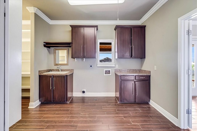 113 Bay Ct, Aransas Pass, TX 78336 - laundry room with electric dryer hookup, cabinet space, dark wood-type flooring, baseboards, and crown molding